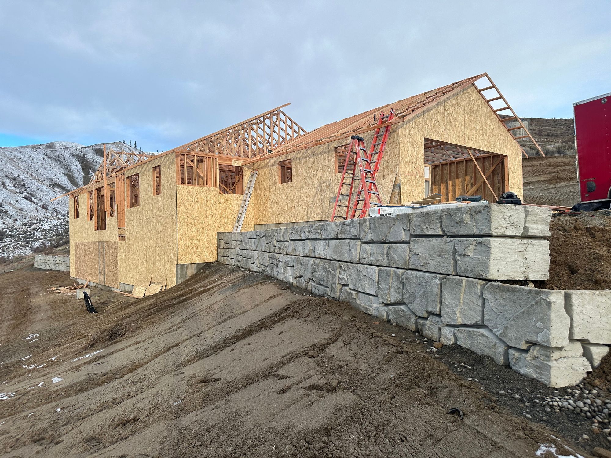 Engineered boulder retaining wall built by Young Bucks in Wenatchee Heights